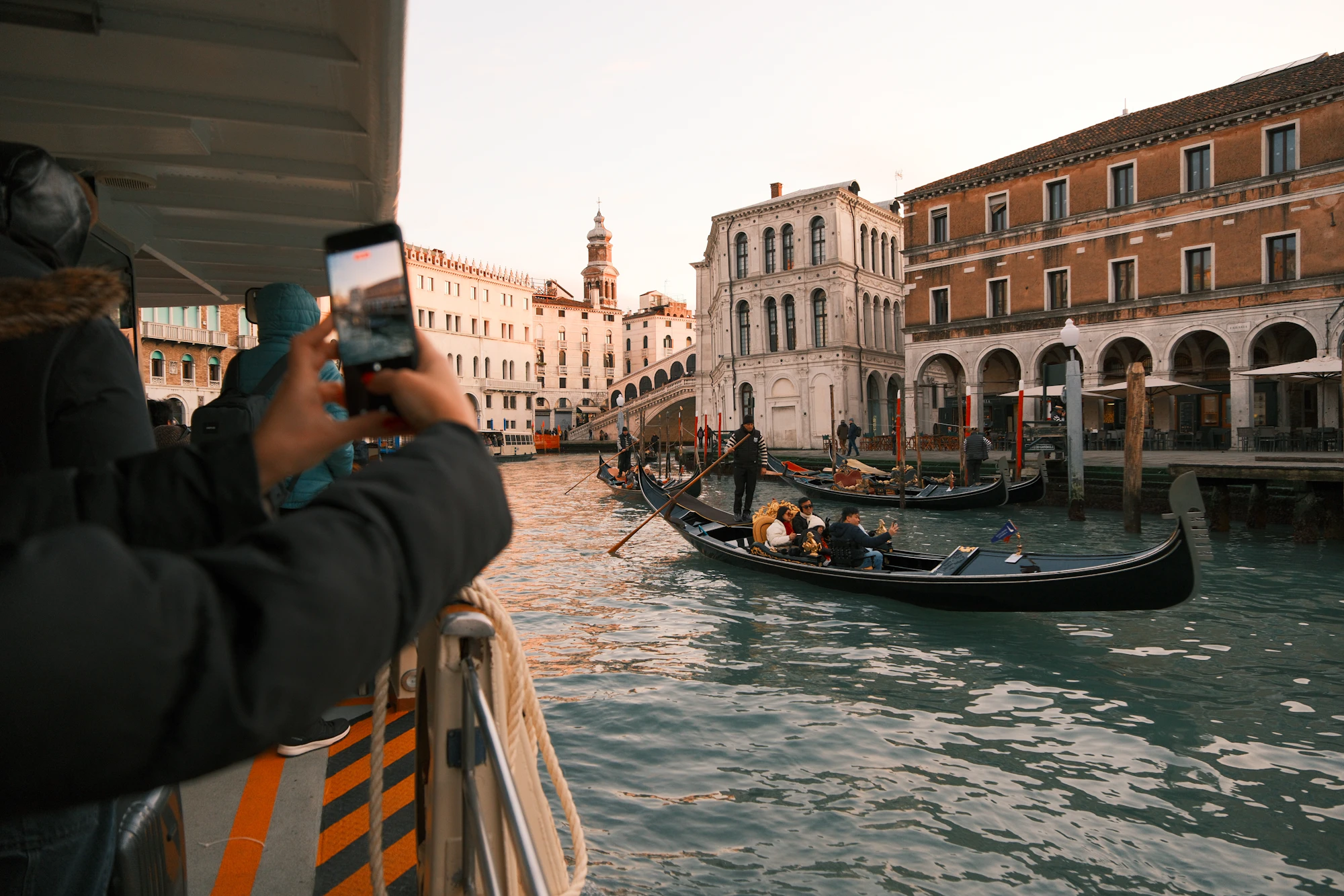Gondolas glide down a canal in venice, italy.