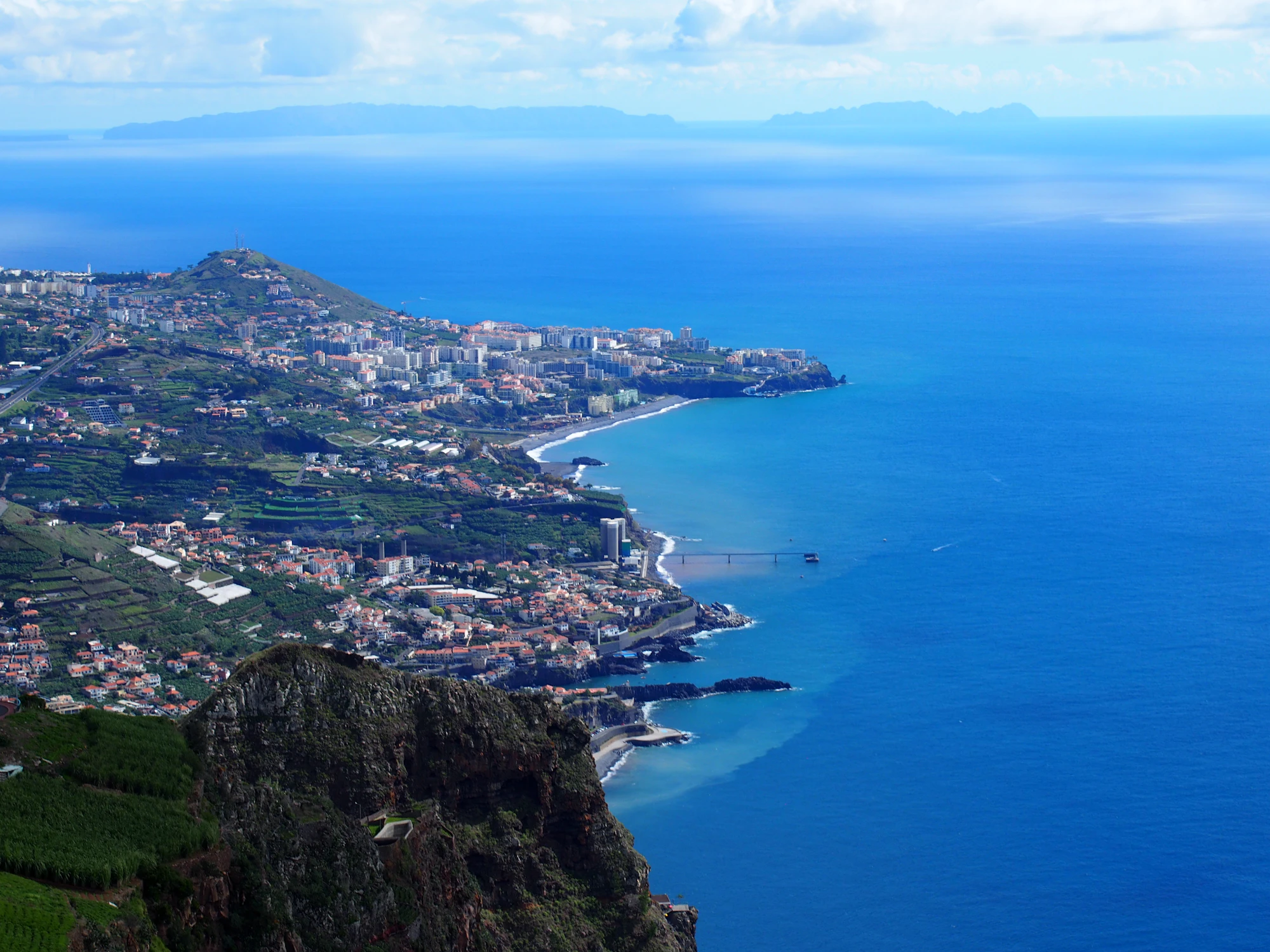 An aerial view of a town and the ocean