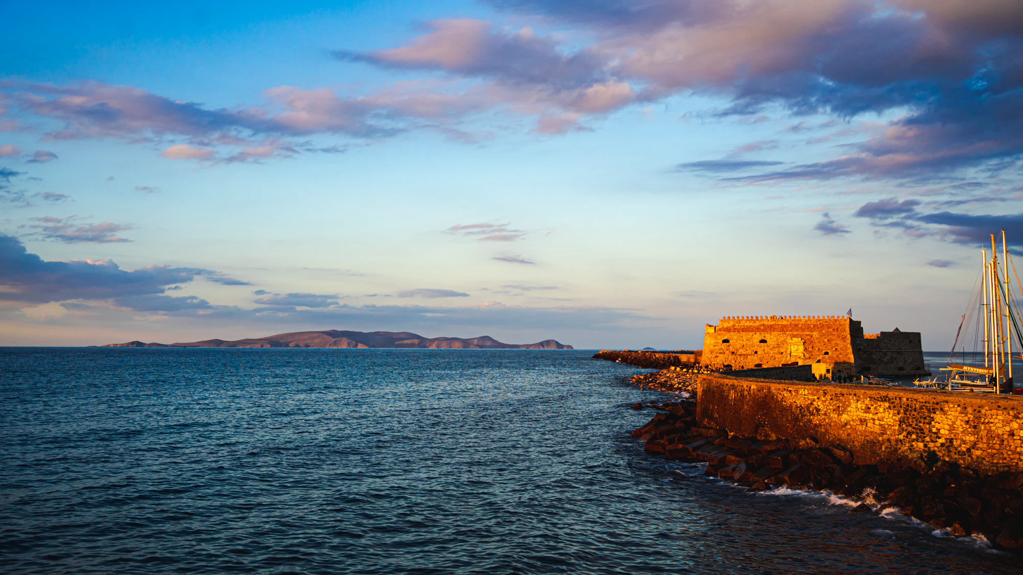 Coastal fortress and calm sea at sunset