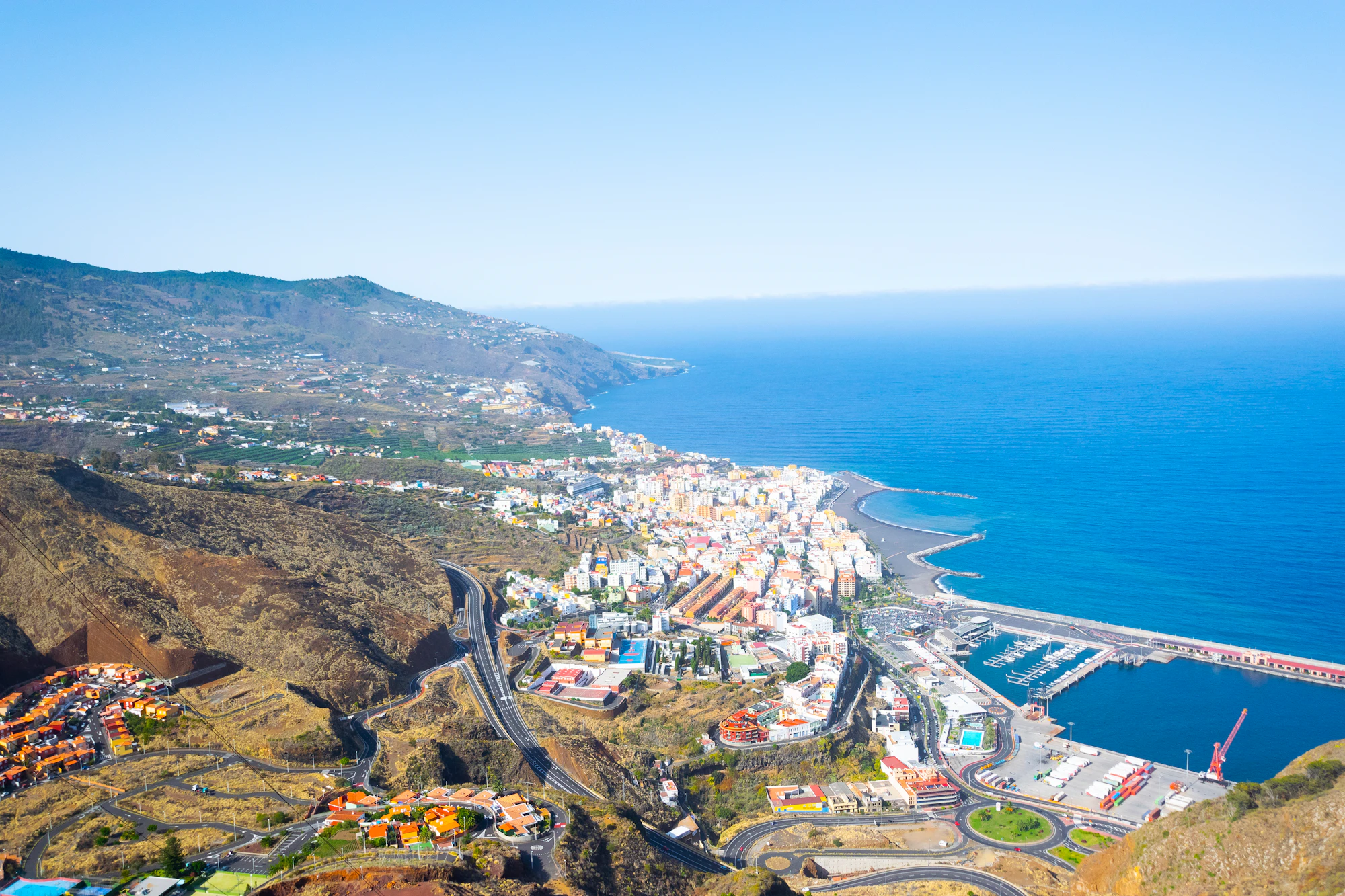 Aerial view of city near body of water during daytime