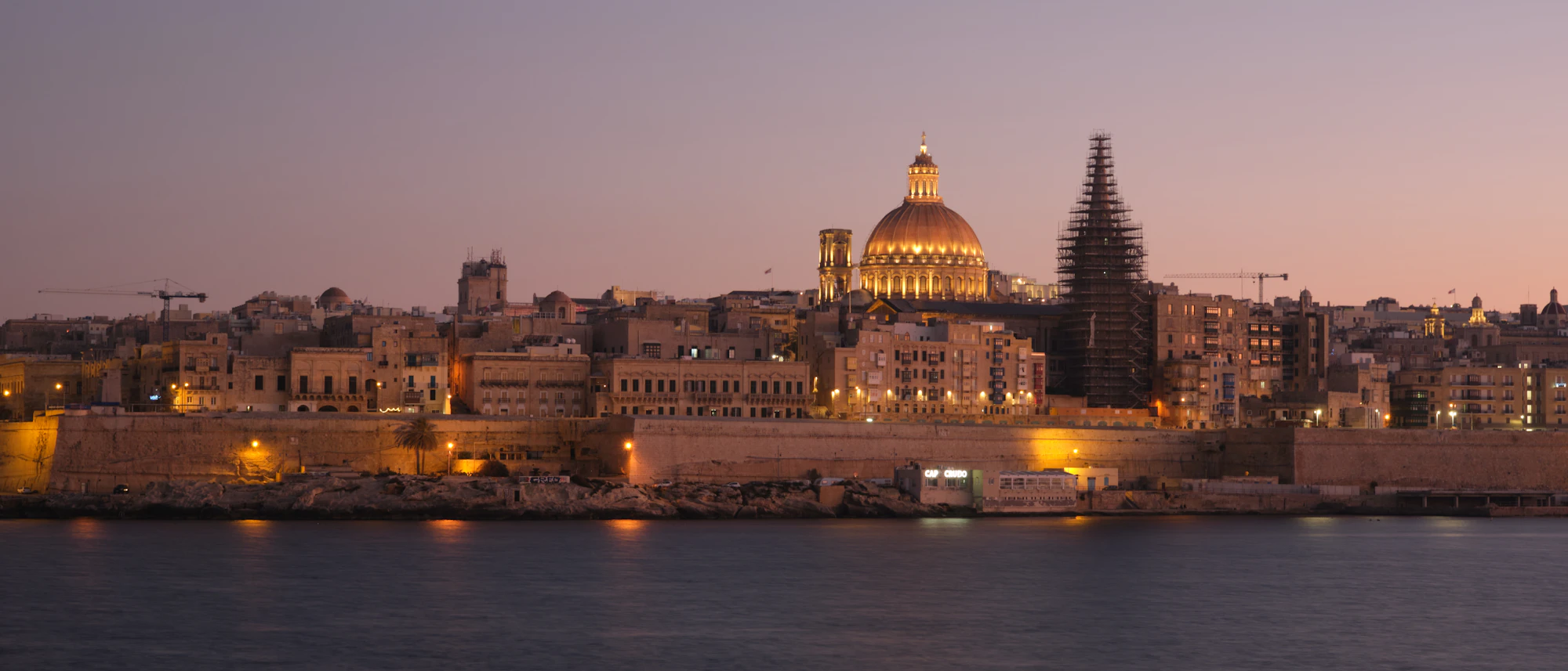 A view of a city at night from across the water