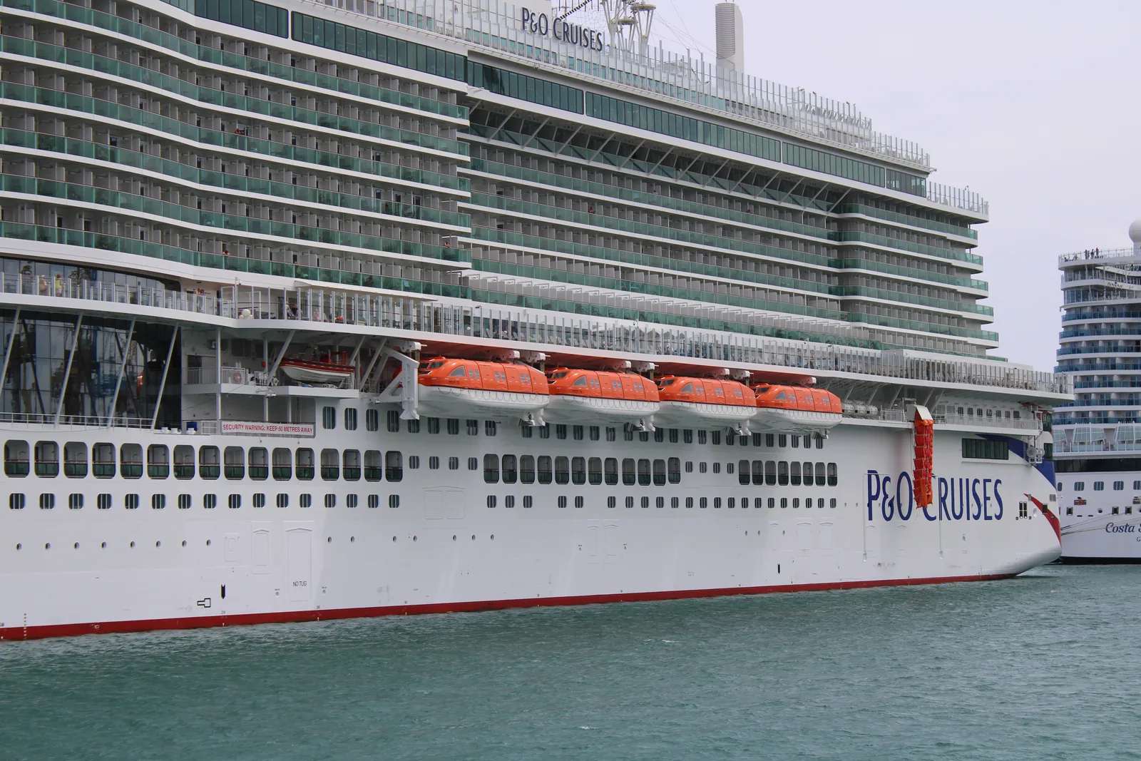 Lifeboats stowed along Arvia's stern above the aft balcony cabins